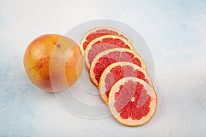 Close-up Grapefruit slices abstract background in Living Coral color of the Year 2020. Bright summer texture