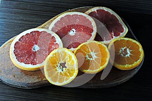 Grapefruit and Mandarin on a wooden Board