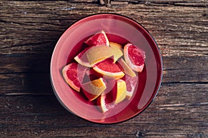 Grapefruit pieces in a red bowl
