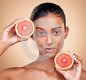 Grapefruit, portrait and beauty of woman in studio for vitamin c benefits, eco cosmetics and nutrition. Face of indian