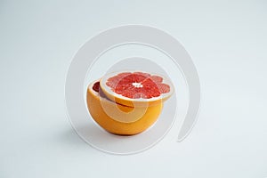 Grapefruit and slice of grapefruit on white background cuted fruit