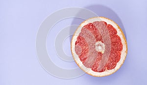 Grapefruit slice isolated on blue with clipping path and shadow