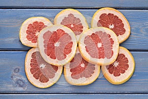 Grapefruit sliced on a blue wooden background