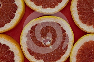 Grapefruit slices on the red background.