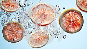 Grapefruit slices in water with bubbles
