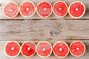Grapefruit slices on wooden table.