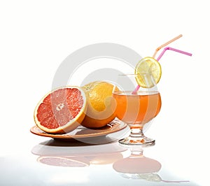 Grapefruits and grapefruit juice on a white gackground