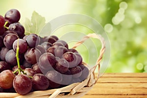 Grapes in basket over nature bokeh background