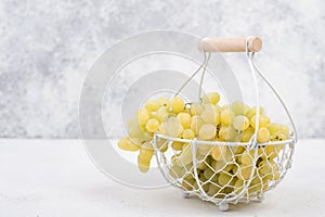 Fresh grapes in a basket on a textured background