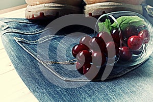Grapes and boots on a jeans and glass .wood background.effect v