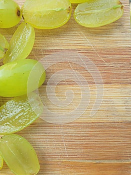 Grapes border on wooden background