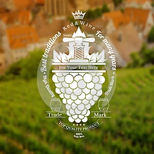 Grapes bunch with leaf and vintage press up. Wine label on vineyard and town blurred background