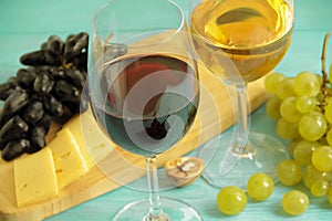 Grapes, a glass of wine on a blue wooden background