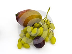 Grapes, mango and plum on white background