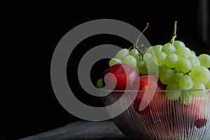 Grapes Nectarines in Dlass plate on a dark Background. Still life photography high quality