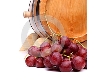 Grapes and old barrel of wine