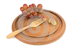 grapes red slice on fork wood on chopping board isolated on whit