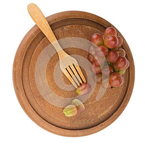 grapes red slice on fork wood on chopping board isolated on whit