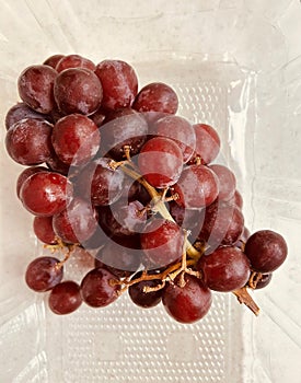 Grapes in a translucent plastic punnet.