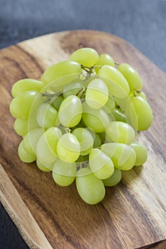 Grapes on wooden board