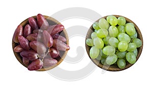 Grapes in a wooden bowl isolated on white background. Blue, red and green grapes.