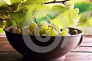 Grapes on wooden table and grape leaves . Healthy fresh fruit wine grapes
