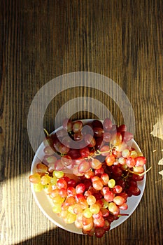 Grapes on wooden table. Vertical food background.