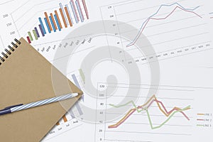 Graph chart and notebook with pen - Business concept