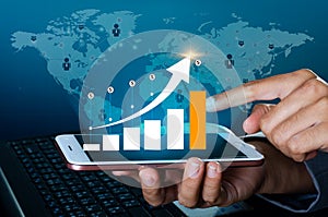 Graph of financial growth global communications Binary Smart Phones and world Internet Business people press the phone to communic