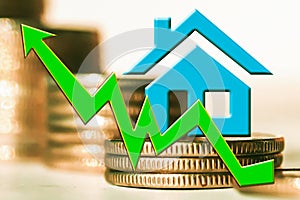 The graph of growth and a symbol of real estate on a background of money .