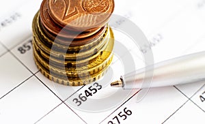 Graph Of Stock Market With Stacks Of Coins And Pen