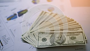 Graph,summary report text and money on the table abstract color