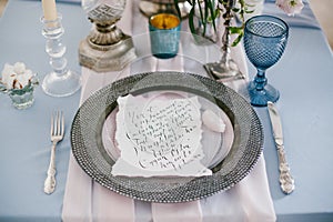 Graphic arts of beautiful wedding calligraphy cards and silver plate.