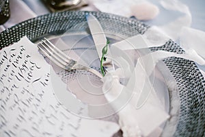 Graphic arts of beautiful wedding calligraphy cards and silver plate with cutlery.