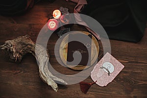 Graphic arts of beautiful wedding pink and brown cards, golden plate with two rings, candles, fabric, snag on wood