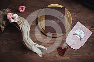 Graphic arts of beautiful wedding pink and brown cards, golden plate with two rings on wood background. roses, snag. Top