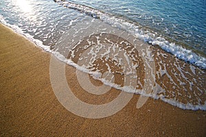 Graphic composition drawn by the sea on the golden and unique sand of Lia beach in Mykonos