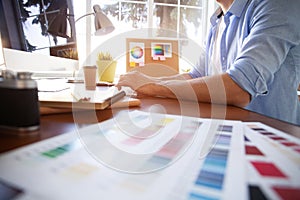 Graphic design and color swatches and pens on a desk. Architectural drawing with work tools and accessories.