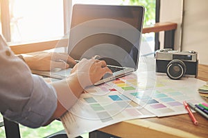 Graphic design and color swatches and pens on a desk. Architectural drawing with work tools and accessories.