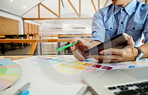 Graphic design and color swatches and pens on a desk. Architectural drawing with work tools and accessories.