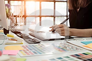 graphic design desk hand using mouse pan sketch device on creative desk.