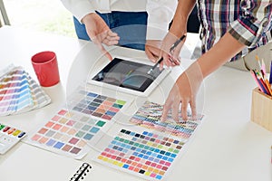 Graphic design meeting with tablet computer on workplace.