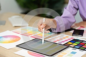 Graphic Design Process. Creative designer using tablet for color selection and design work.