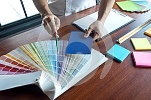 Graphic designer choose colors from the color bands samples for design .Designer graphic creativity working concept