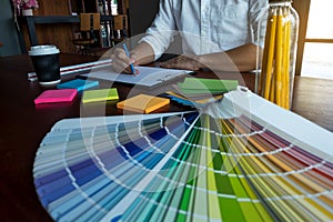 Graphic designer choose colors from the color bands samples for design .Designer graphic creativity working concept