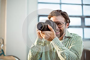 Graphic designer clicking photo from digital camera