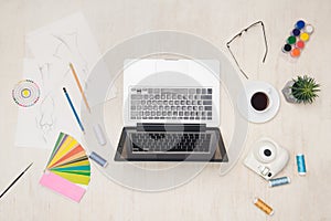 Graphic designer desk essentials top view with wooden texture background