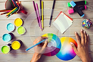 Graphic designer drawing on colour chart