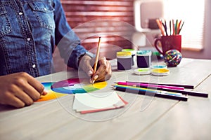 Graphic designer drawing on colour chart