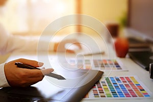 Graphic designer hands using digital tablet and computer.